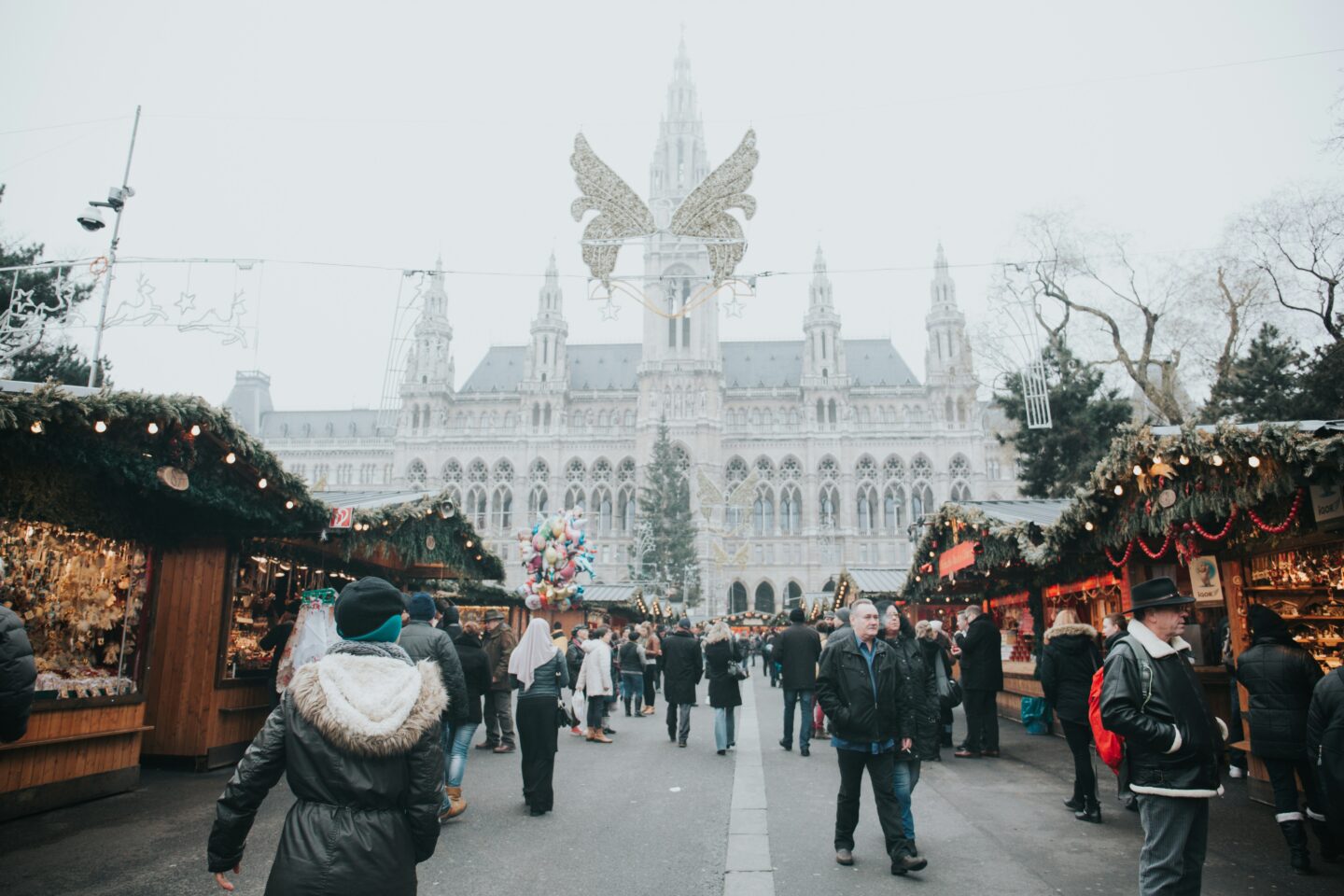 Busy winter market outside historic city hall with decorations